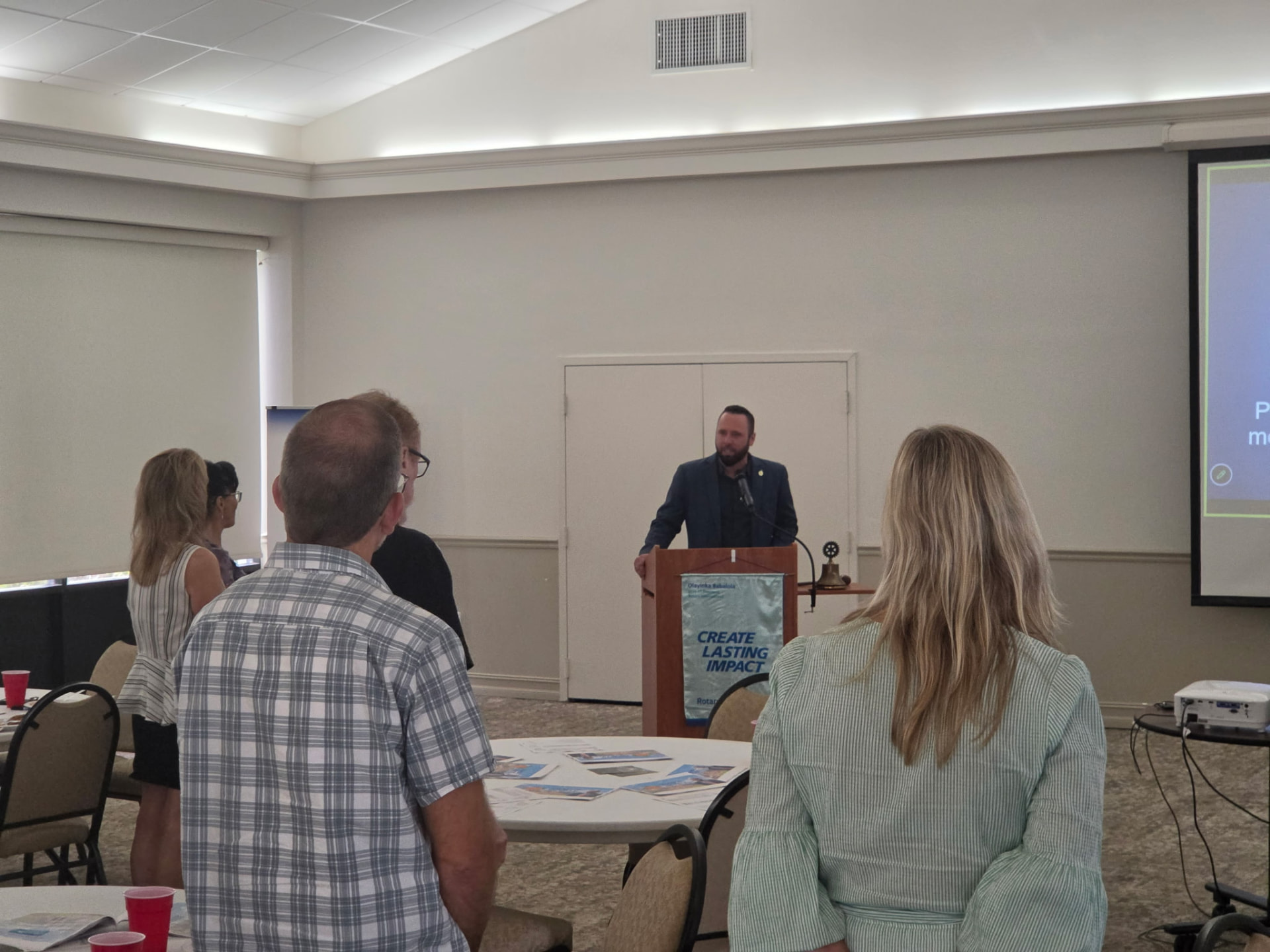 Austin Arthur speaking from the podium as Chaplain at a Winter Garden Rotary Club meeting in West Orange County, Florida
