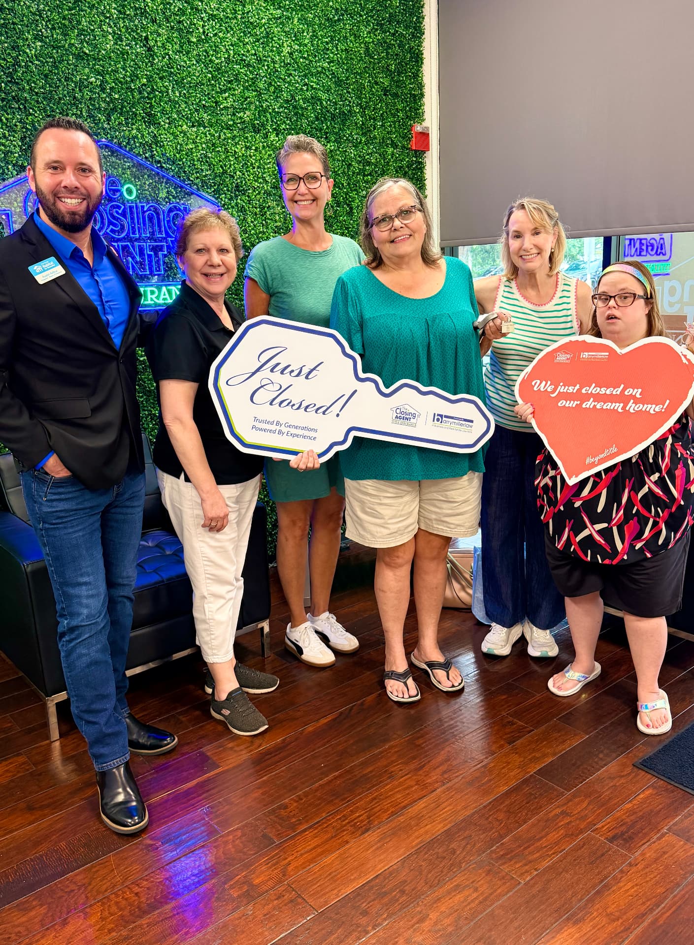 Austin Arthur with a West Orange Habitat for Humanity family celebrating their new home closing in West Orange County, Florida