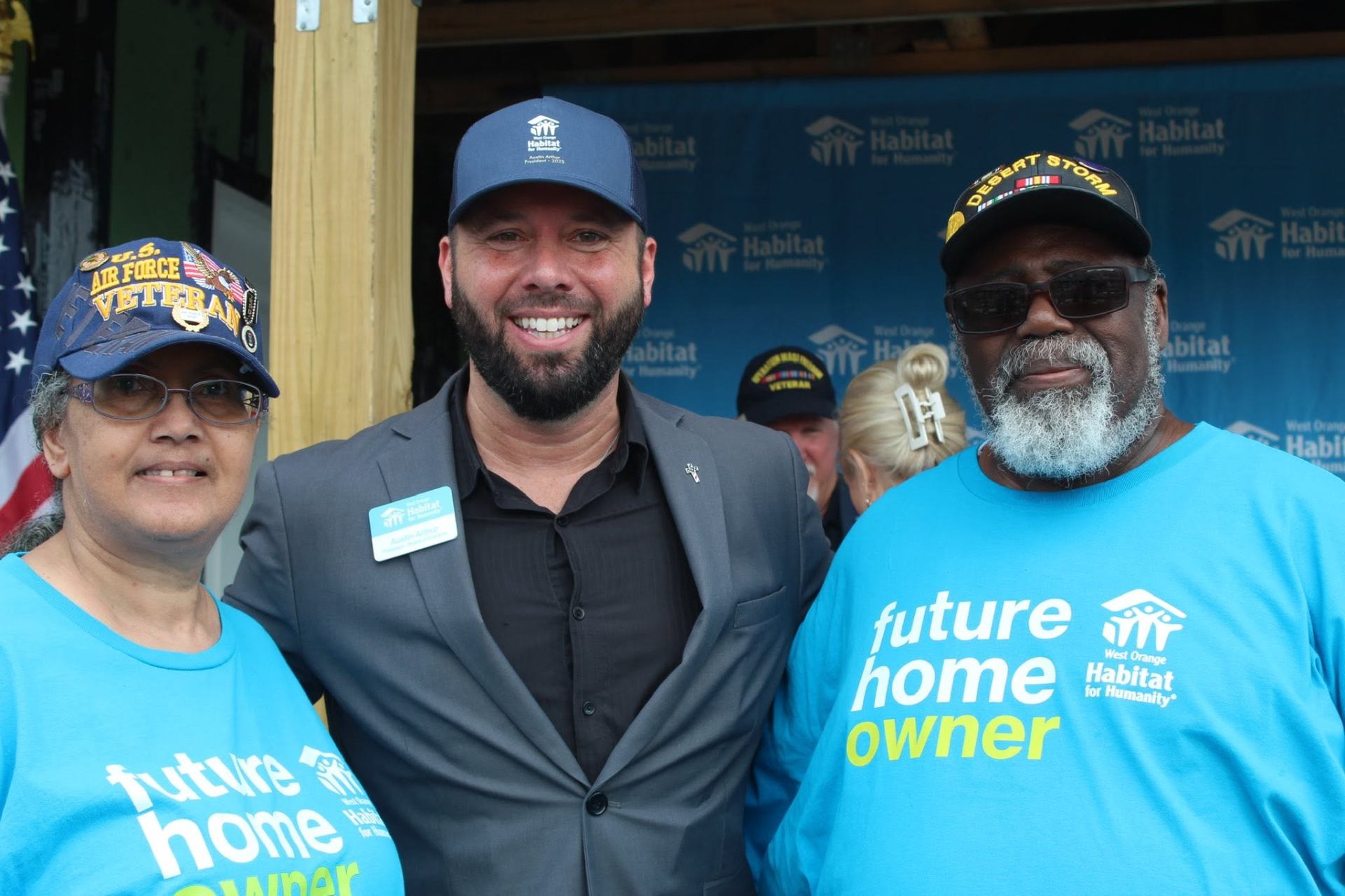 Austin Arthur with two future Habitat homeowners, a U.S. Air Force veteran and a Desert Storm veteran