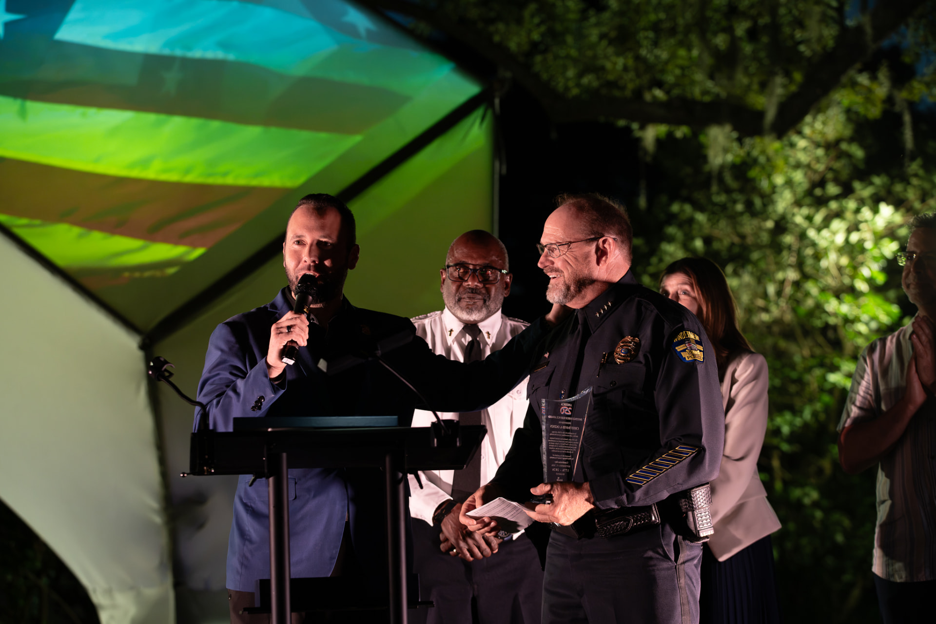 Austin Arthur presenting the America 250 Achievement Award to Windermere Police Chief David Ogden for public service leadership