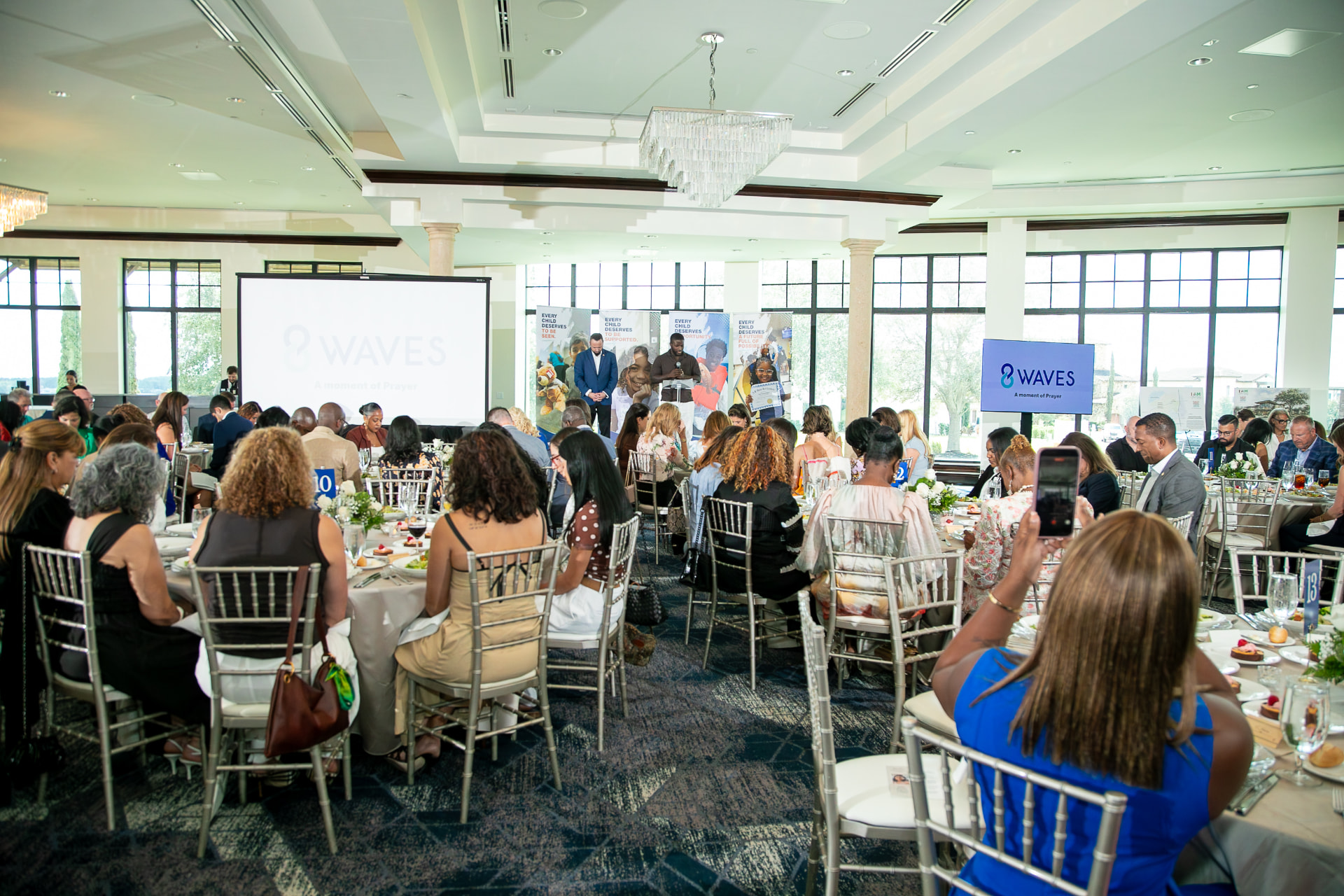 A moment of prayer during the 2026 8 Waves WaveMaker Luncheon