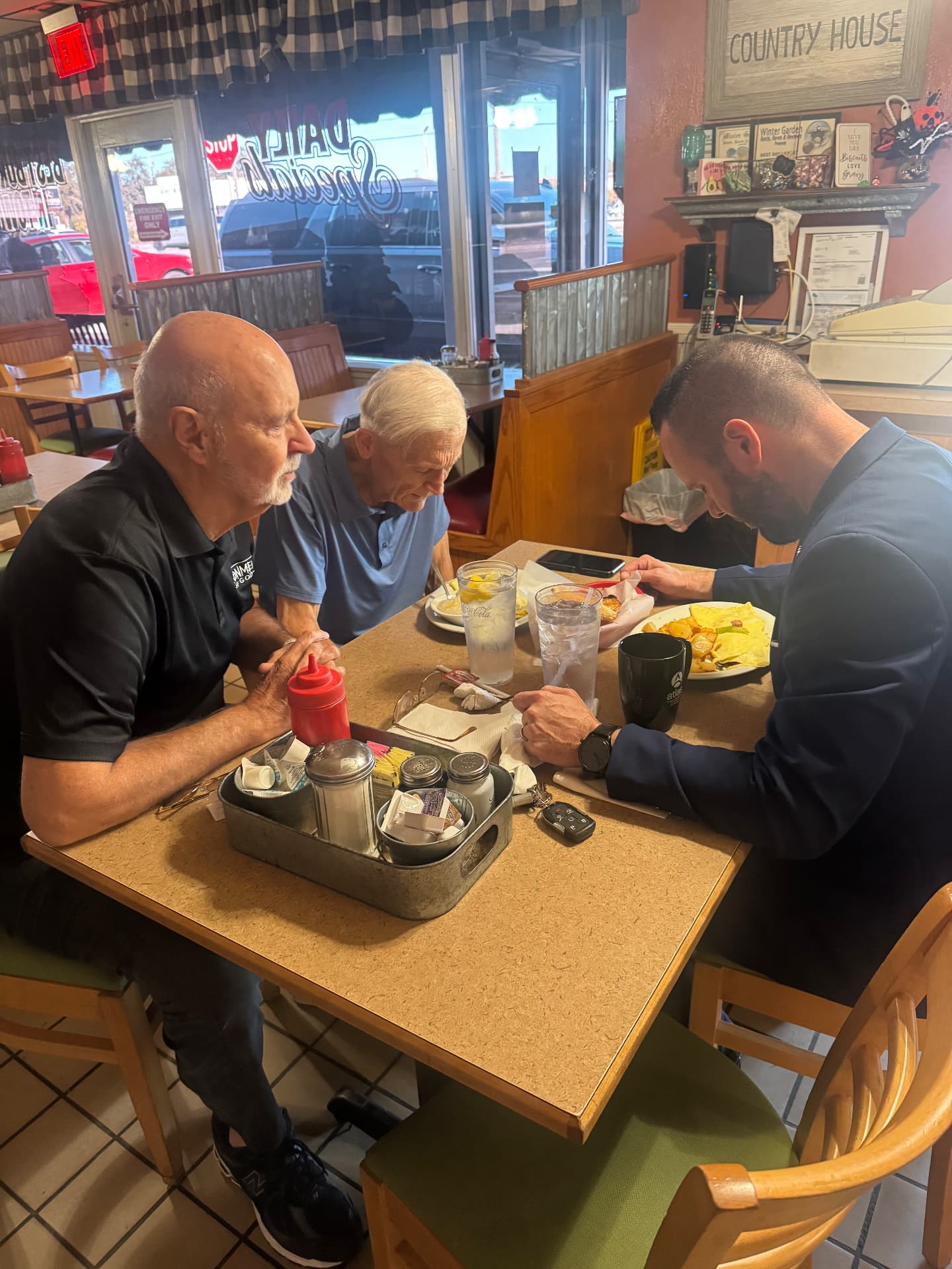 Austin Arthur praying with Bishop David over breakfast