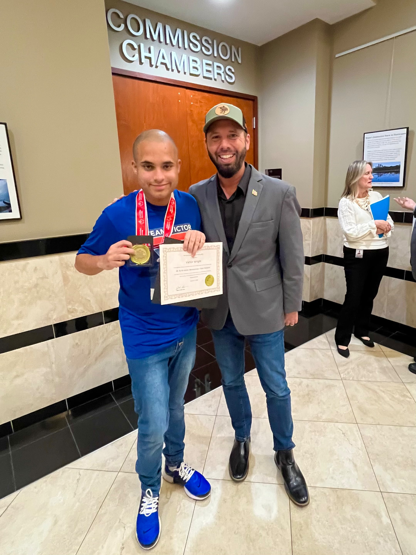 Austin Arthur with Victor Wright, Special Olympics gold medalist from Winter Garden, at the Commission Chambers