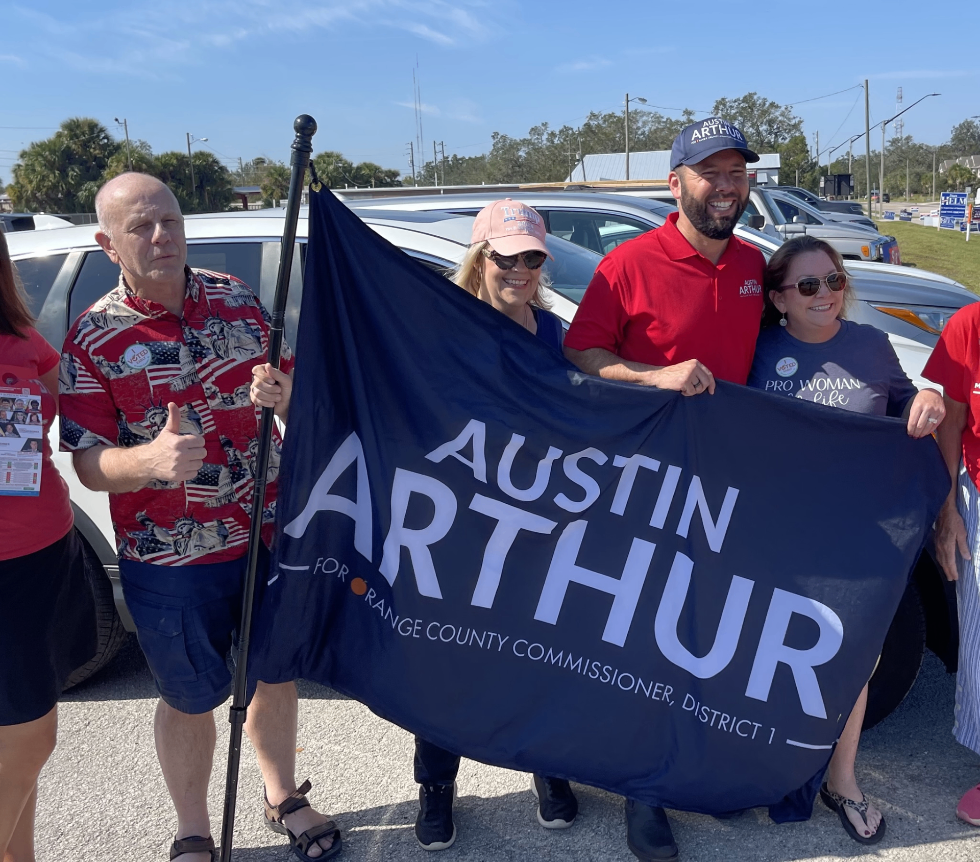 Austin Arthur supporters holding a campaign flag for Orange County Commissioner, District 1
