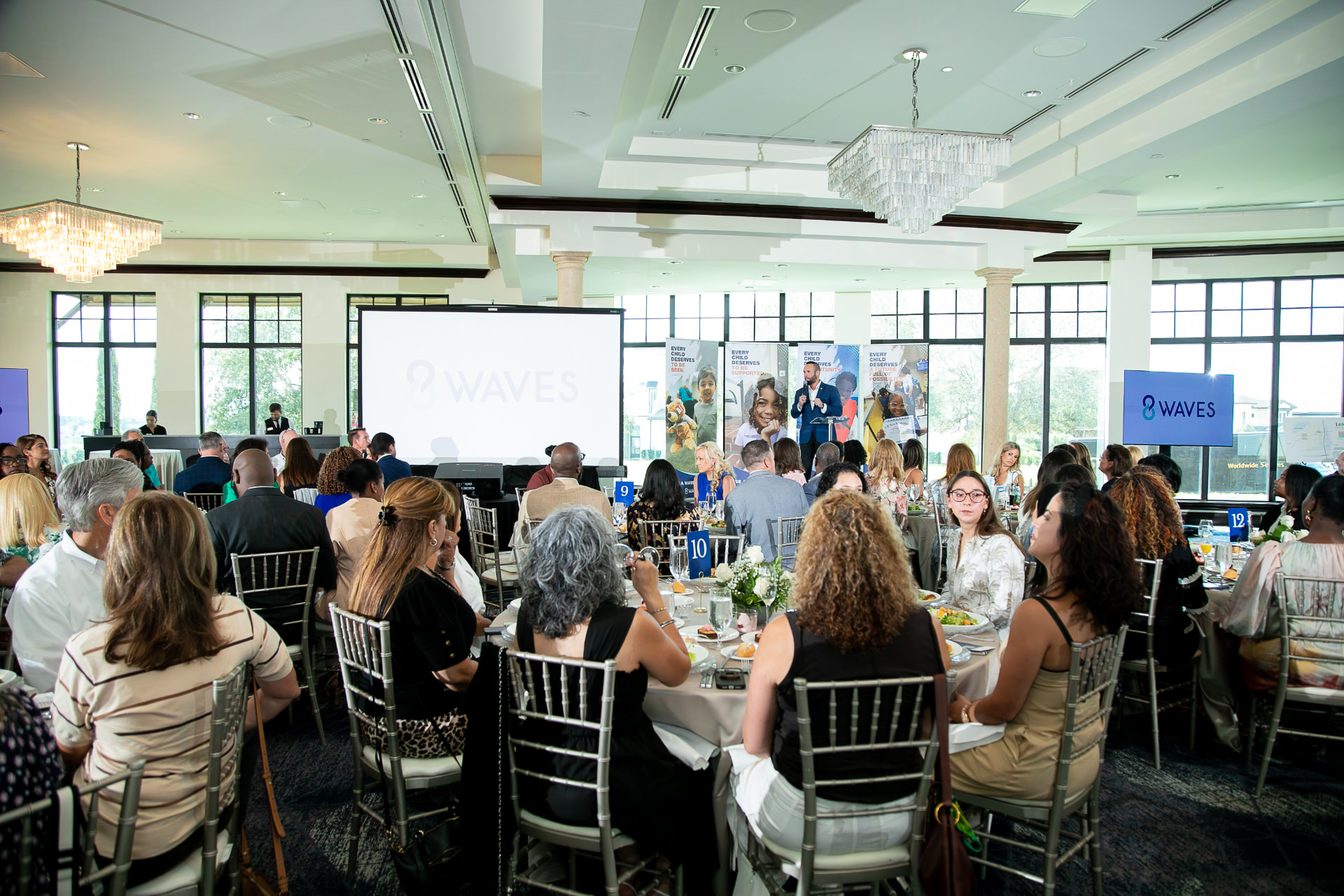 A full ballroom at the 2026 8 Waves WaveMaker Luncheon at Bella Collina