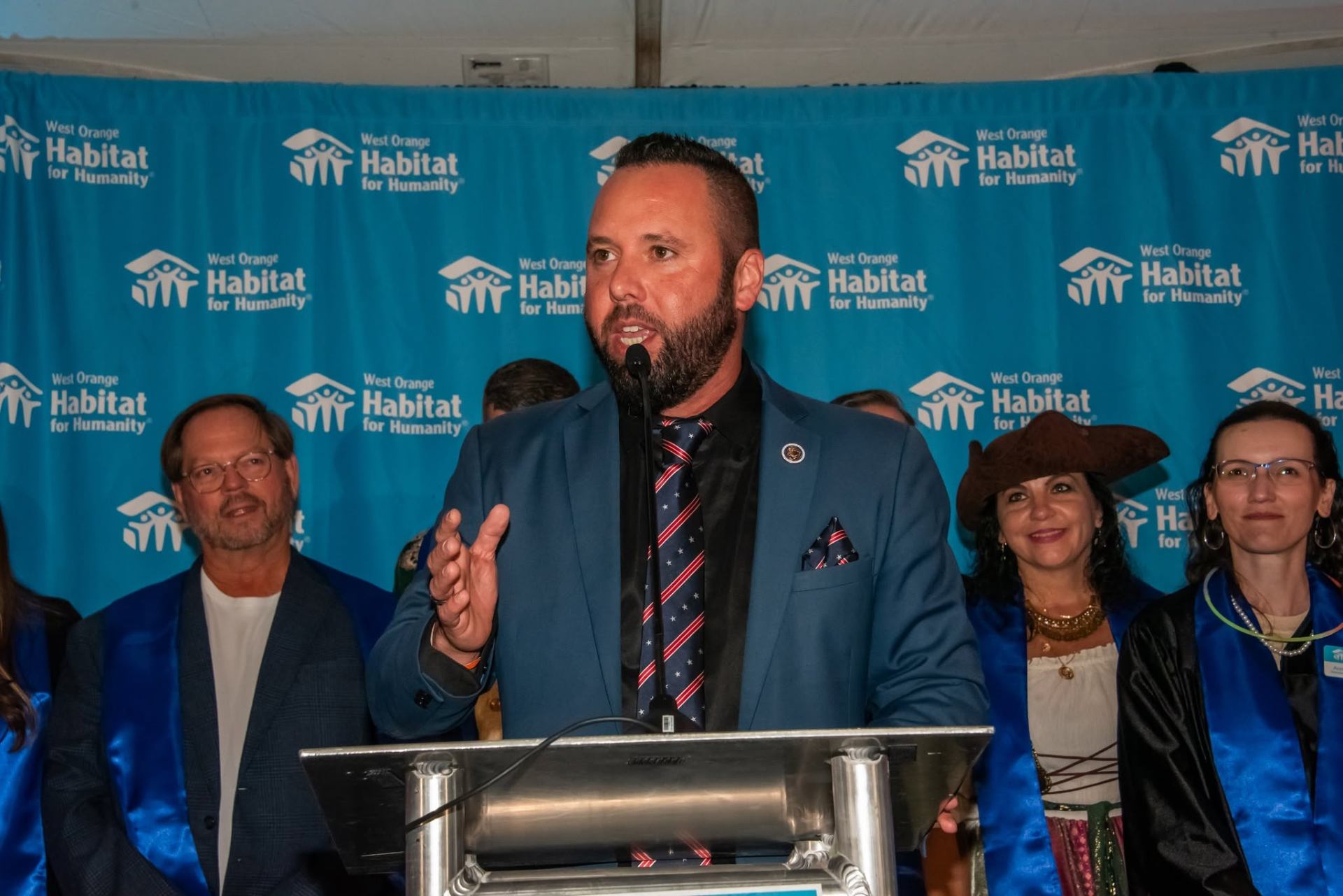 Austin Arthur speaking at the West Orange Habitat for Humanity podium