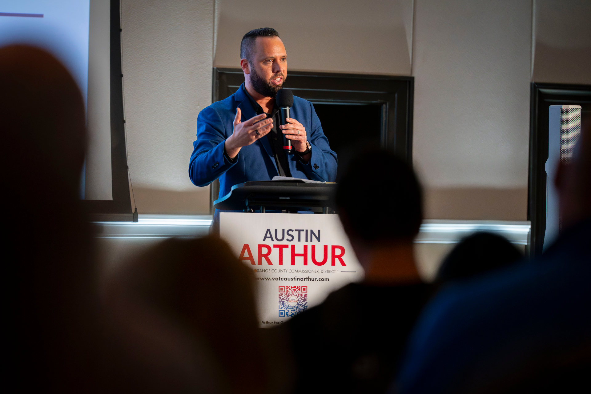 Austin Arthur at the rally-to-victory podium addressing supporters