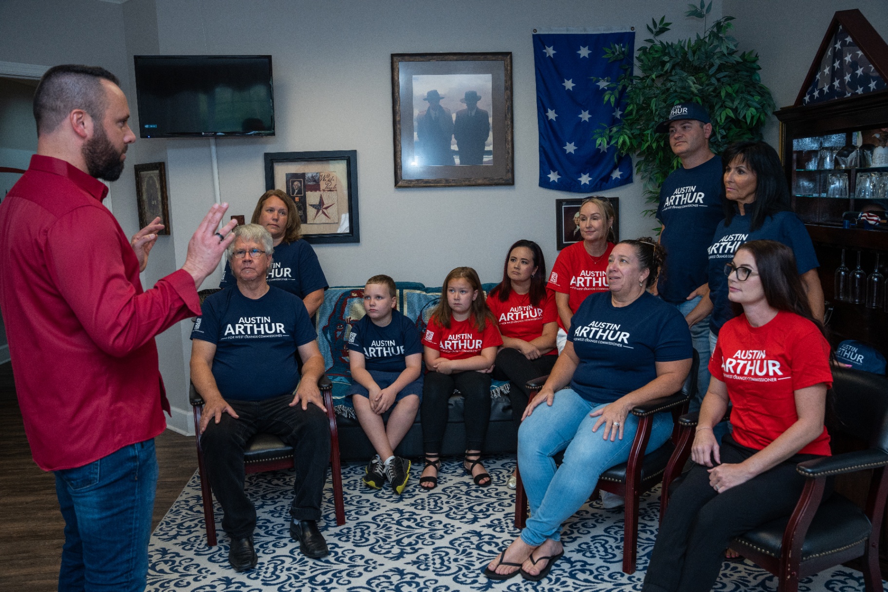 Austin Arthur speaking with grassroots supporters in campaign shirts
