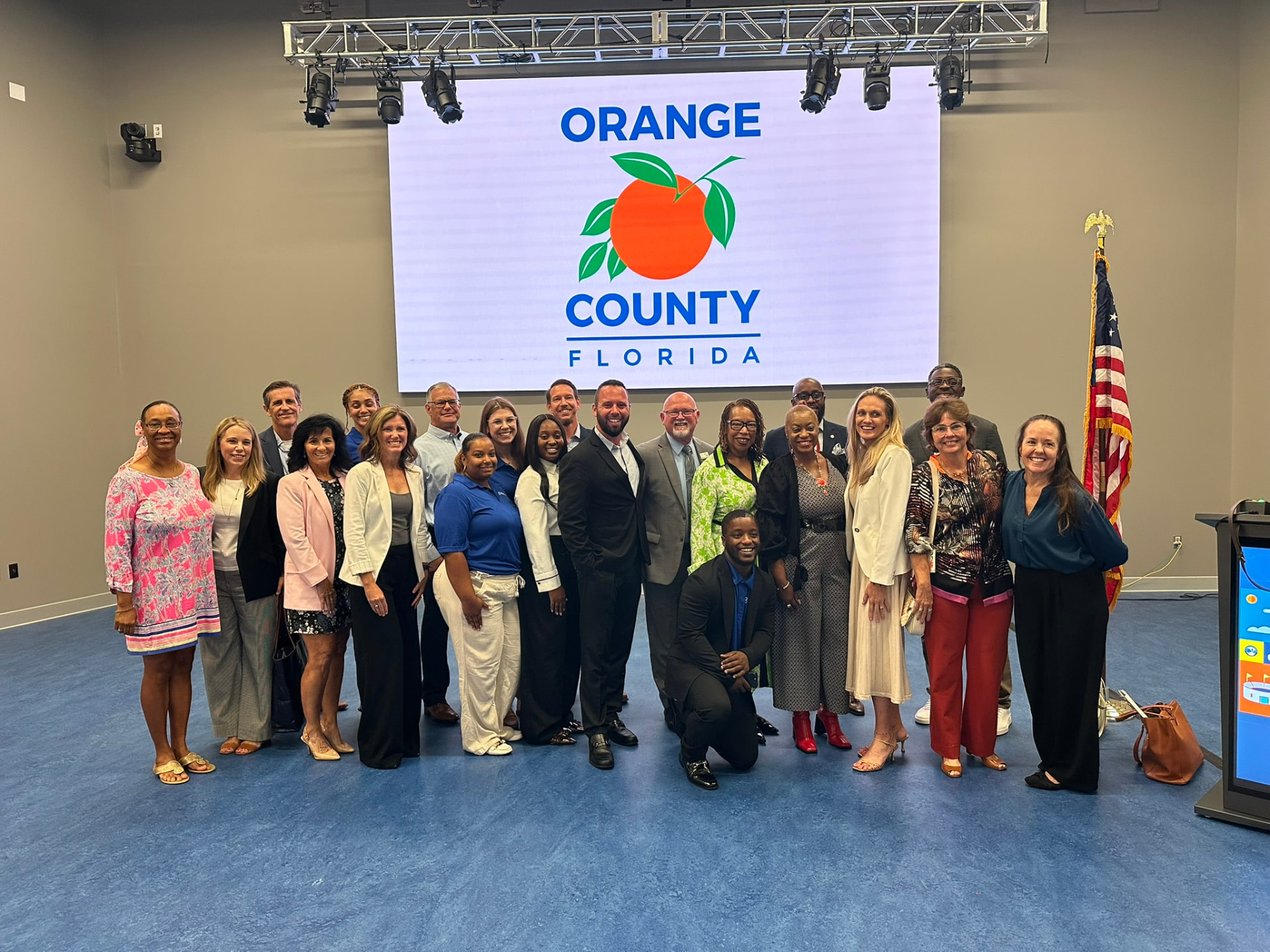 Austin Arthur with Orange County Board of County Commissioners Commissioner Nicole Wilson, District 1, and Sara Myer, founder of 8 Waves, and leaders supporting the I AM Children's Museum in Winter Garden, Florida