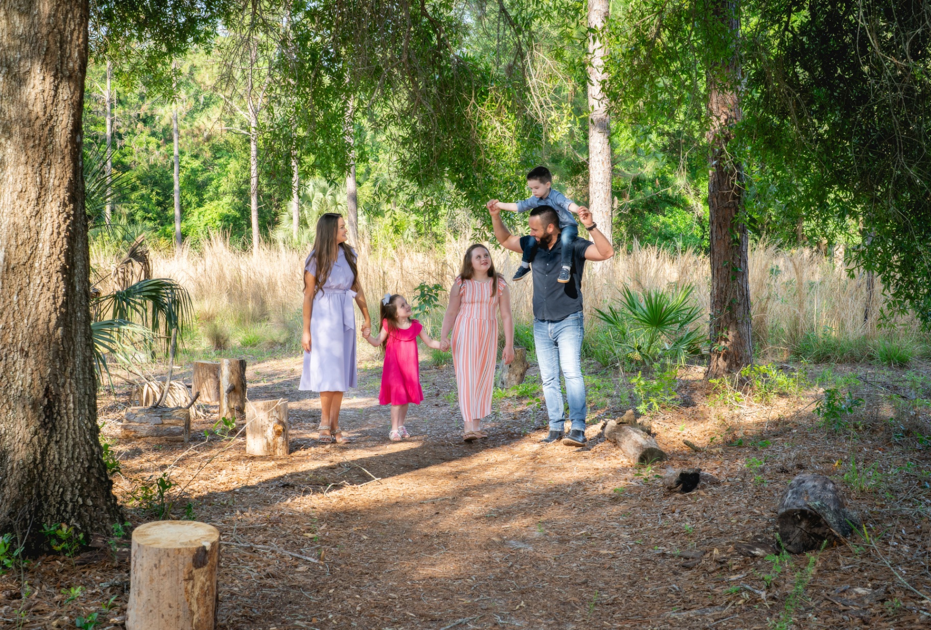Austin Arthur walking through the Florida woods with his wife Kellie and their three children.