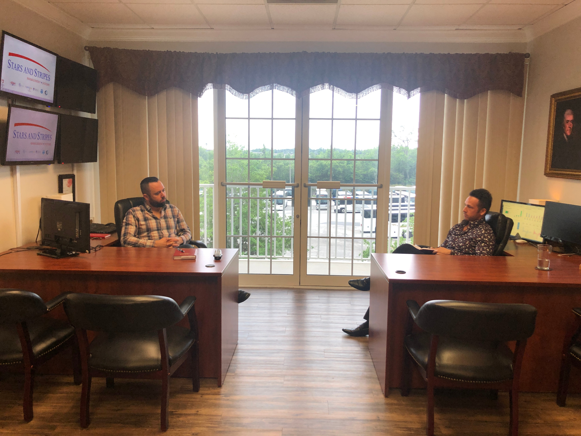 Austin and Zander Arthur at their desks in the Stars and Stripes office